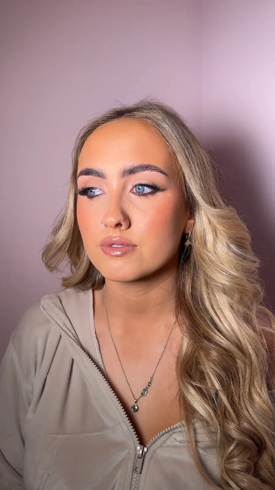 Soft glam makeup with a lilac eye on blue eyes