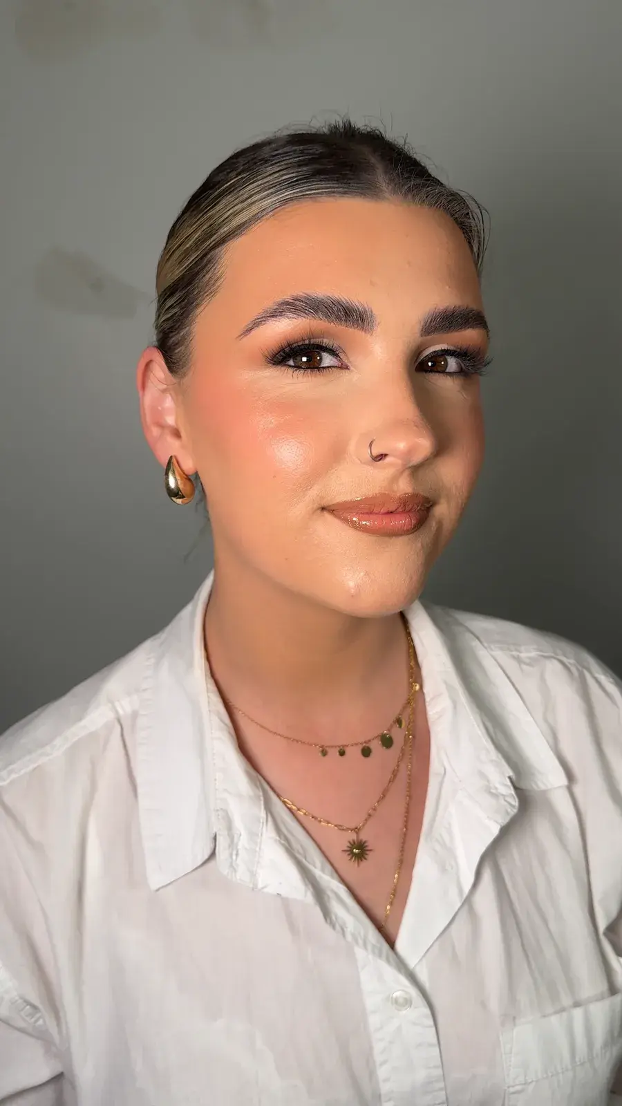 Soft glam makeup with bronzed skin and a glossy nude lip