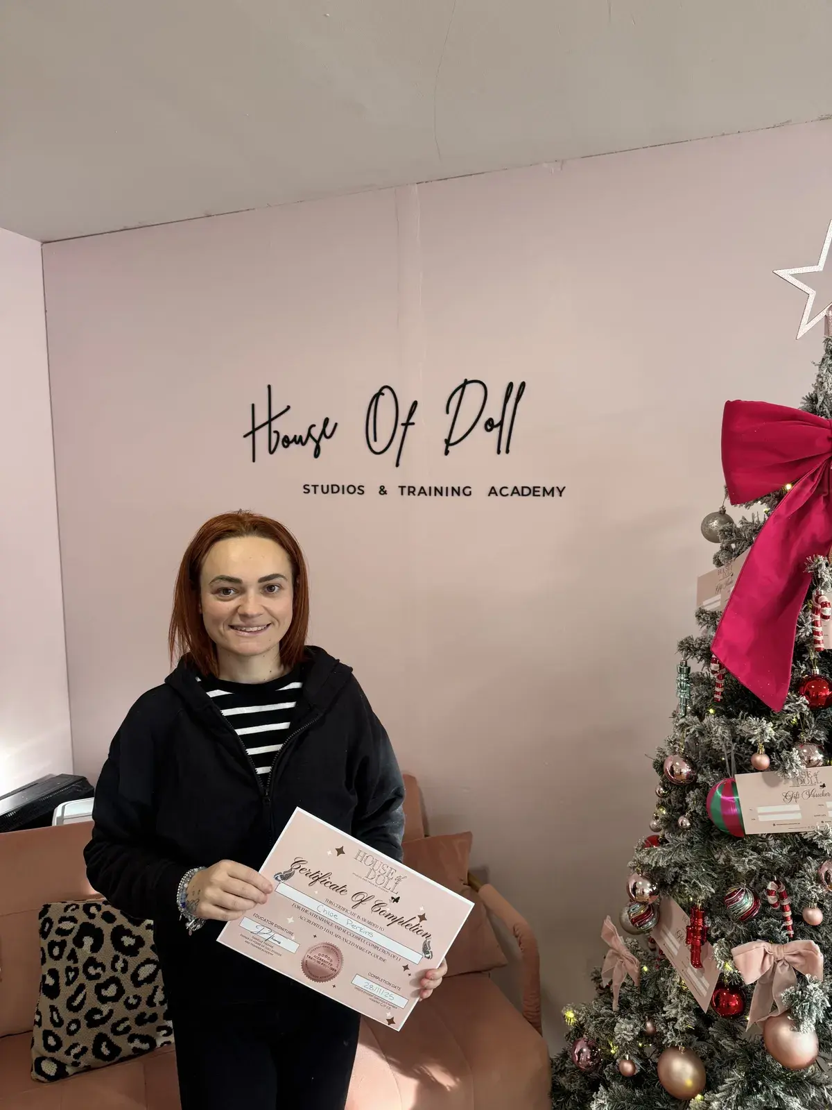Newly qualified makeup artist holding her 3-day course certificate